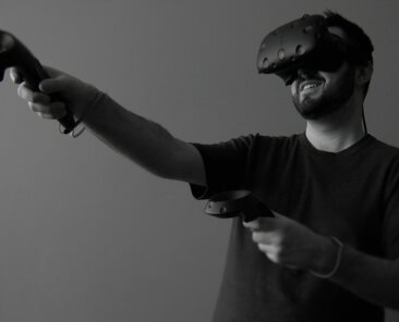 Man using a VR headset and hand controllers
