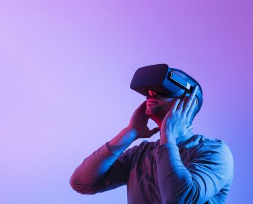 Person wearing a VR headset under purple and blue light