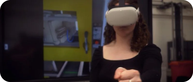 Trainee using hand tracking in VR for injection moulding training