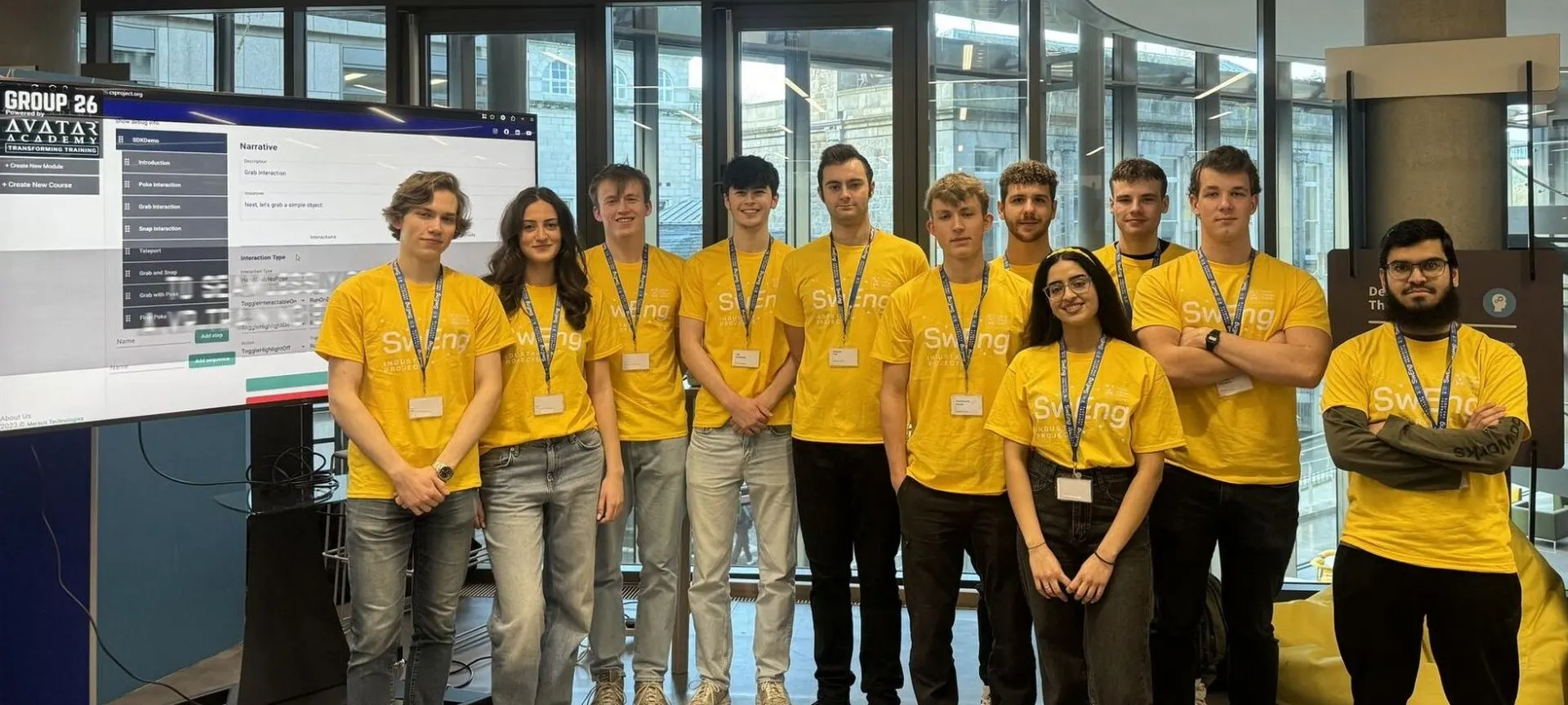 Trinity College Dublin SwENG students beside an Avatar Academy screen